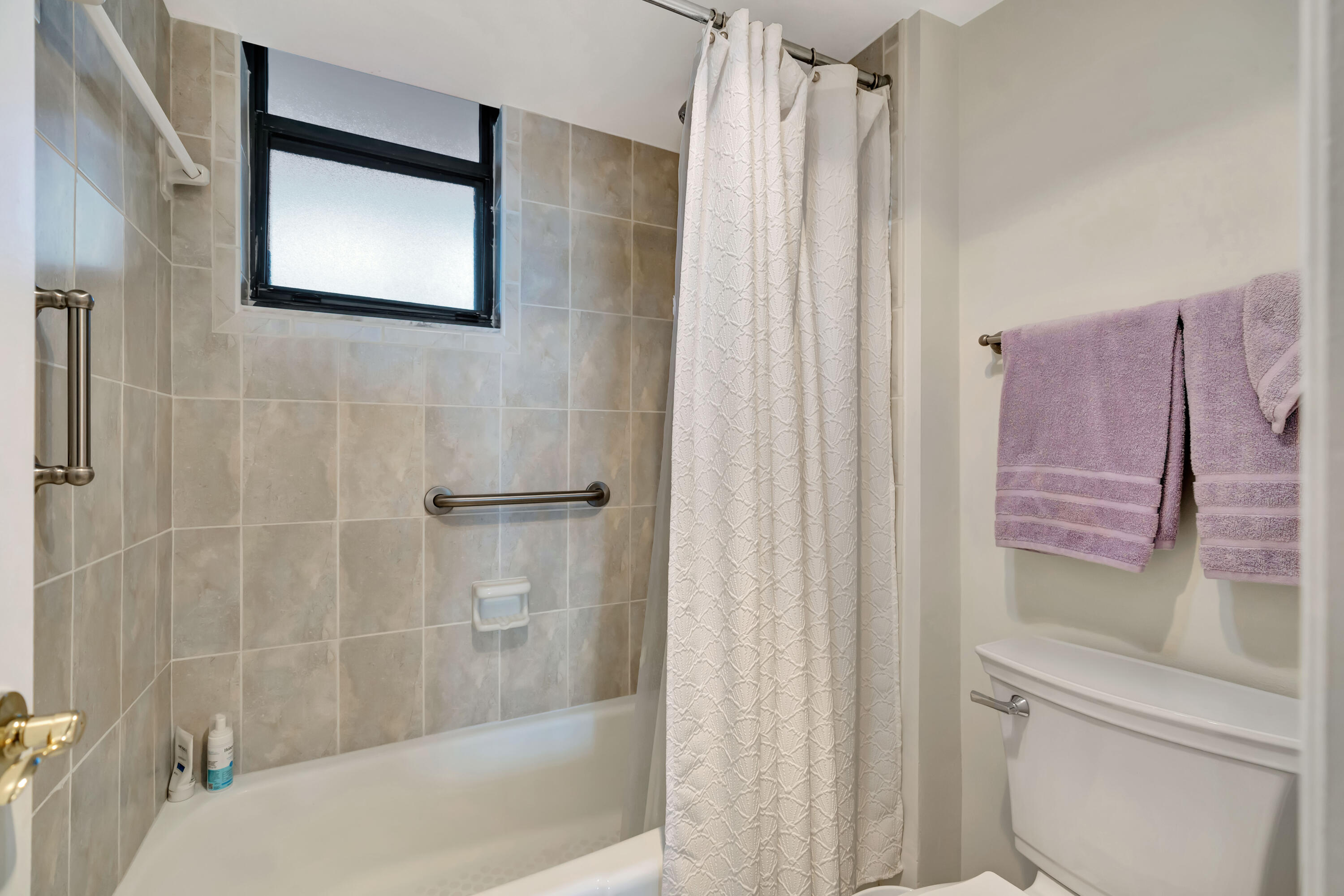 1542 Jupiter Cove Drive, Unit 104 Jupiter, FL 33469 - Photo 34 of 65 a bathroom with a shower and a toilet