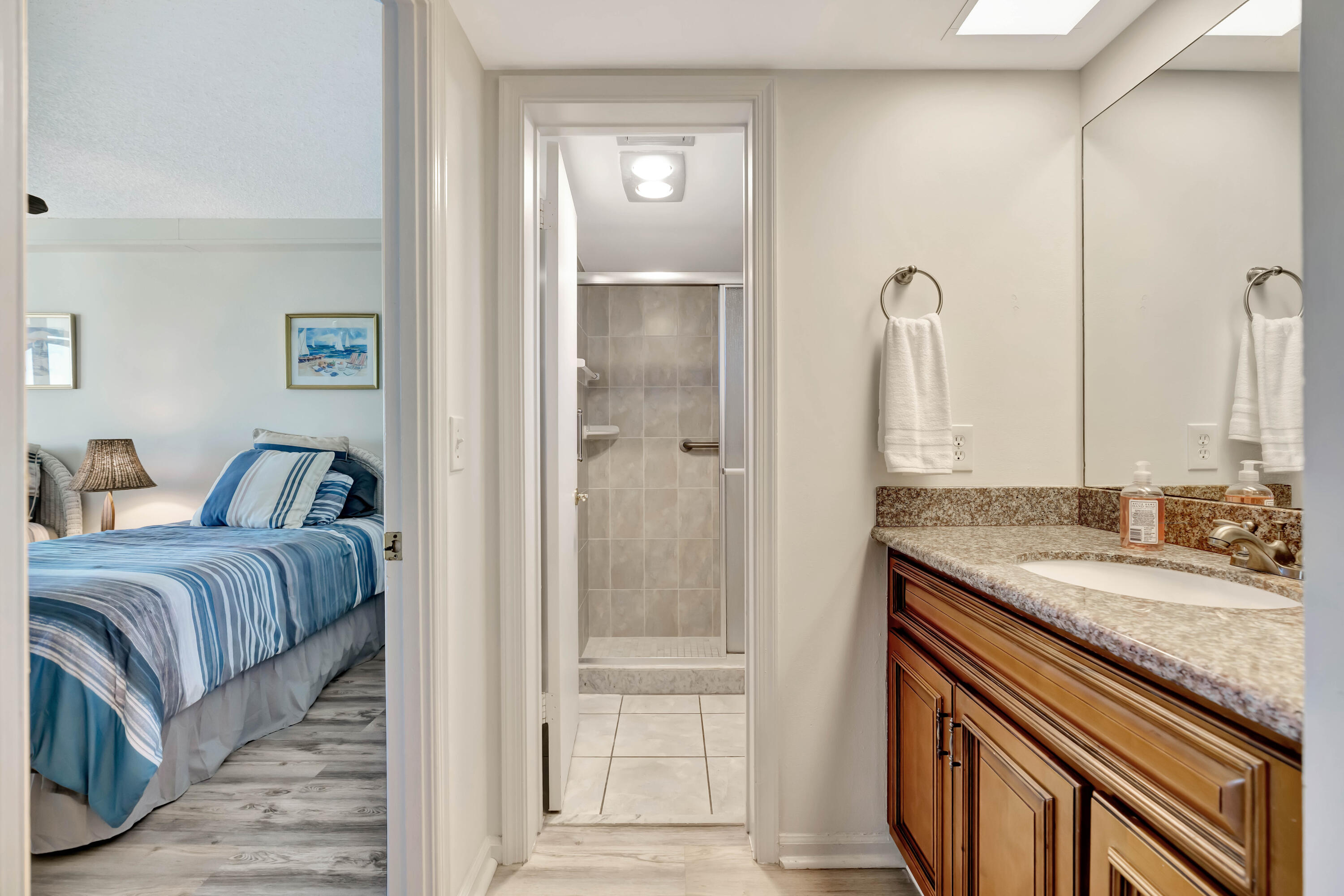 1542 Jupiter Cove Drive, Unit 104 Jupiter, FL 33469 - Photo 42 of 65 a en suite bathroom with a granite countertop sink and a mirror