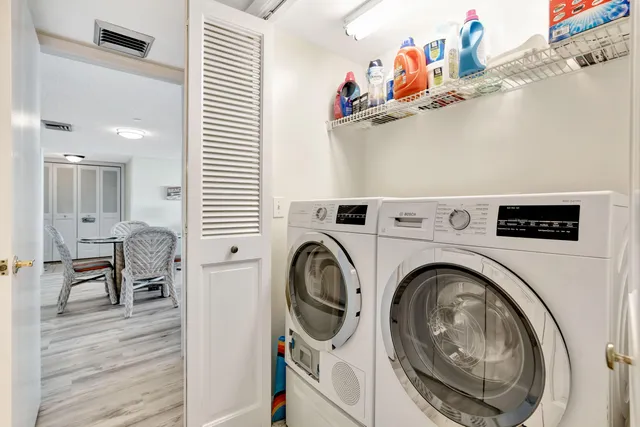 a front view of multi story residential apartment building with yard and green space