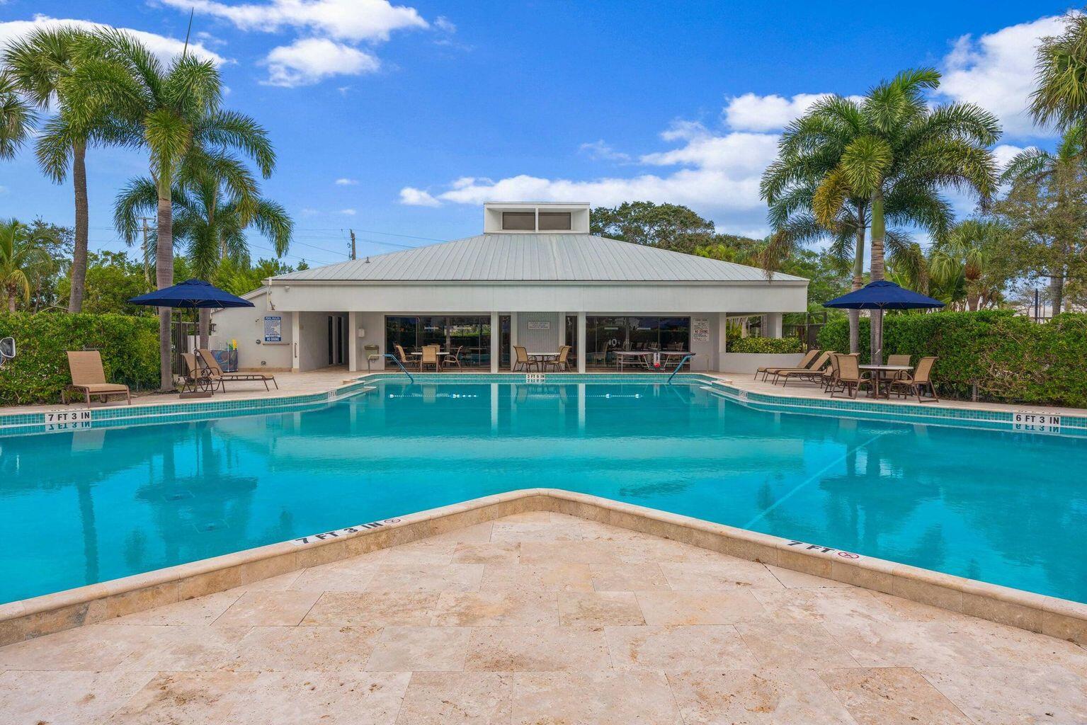 1542 Jupiter Cove Drive, Unit 104 Jupiter, FL 33469 - Photo 59 of 65 an outdoor view of house with swimming pool and green space