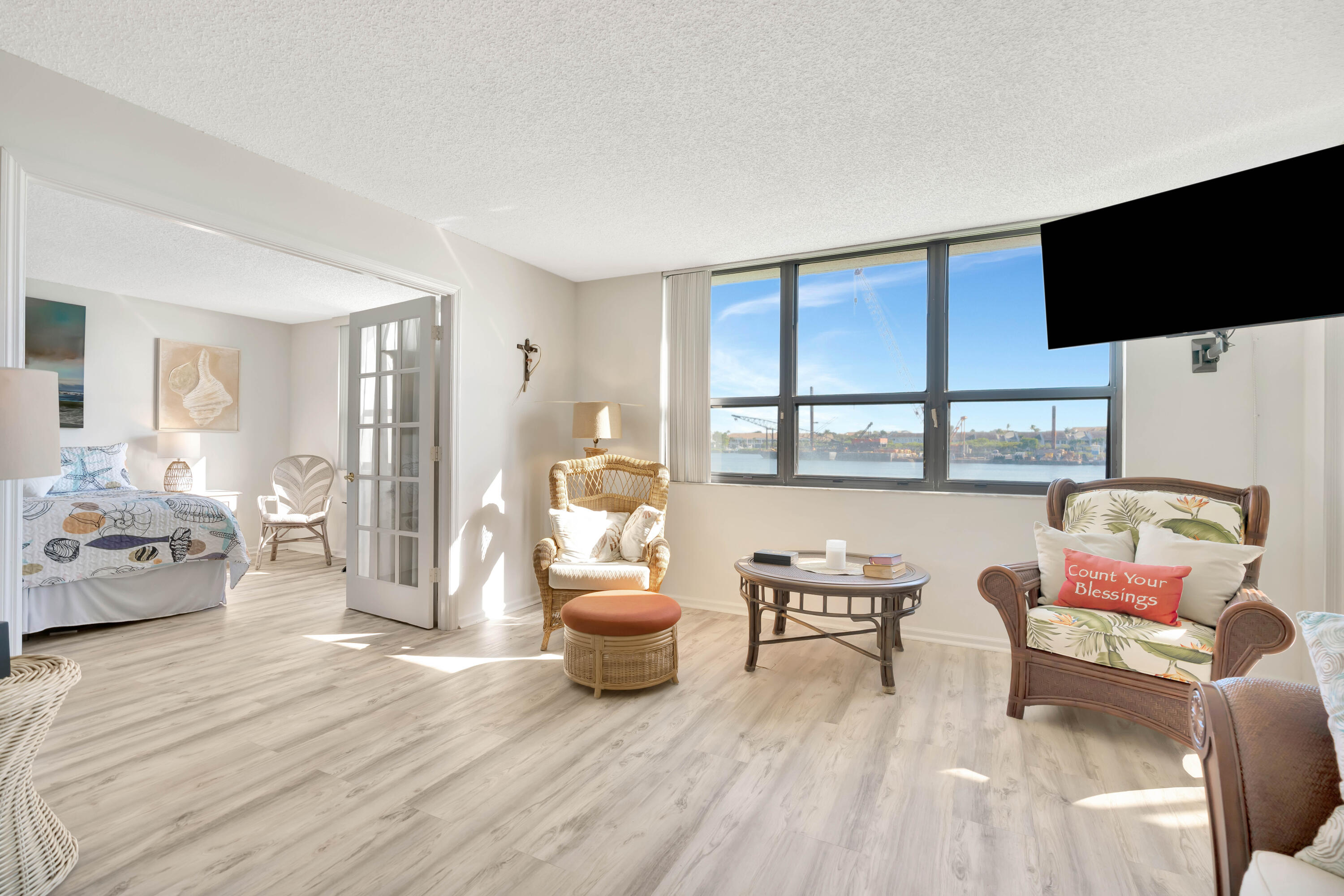 1542 Jupiter Cove Drive, Unit 104 Jupiter, FL 33469 - Photo 7 of 65 a living room with furniture and a flat screen tv