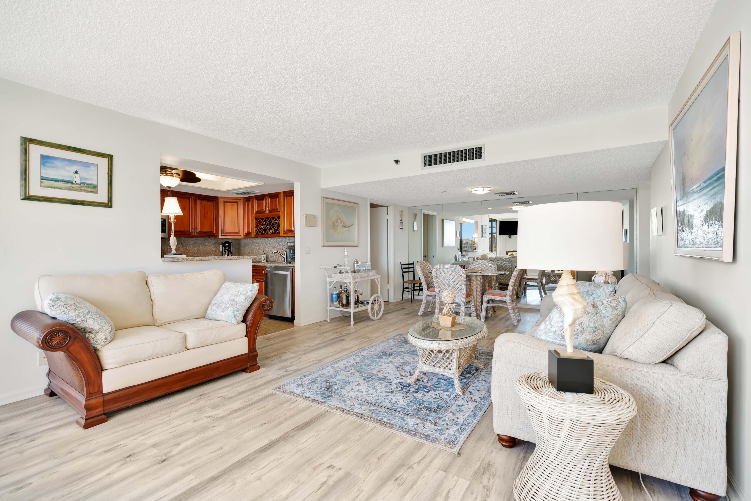 1542 Jupiter Cove Drive, Unit 104 Jupiter, FL 33469 - Photo 9 of 65 a living room with furniture and a wooden floor