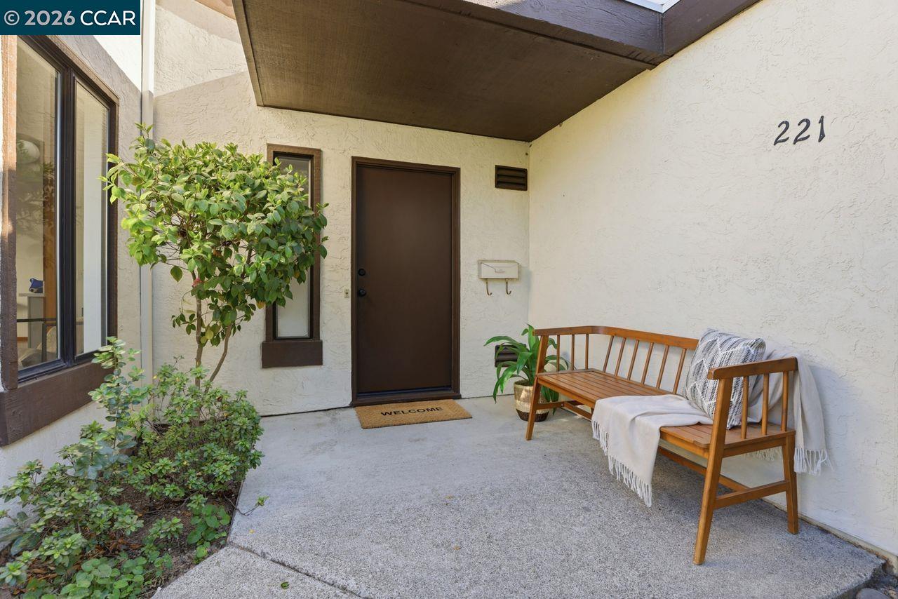 a balcony with furniture and potted plants