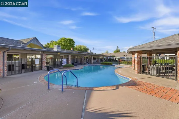 an outdoor space with pool and furniture