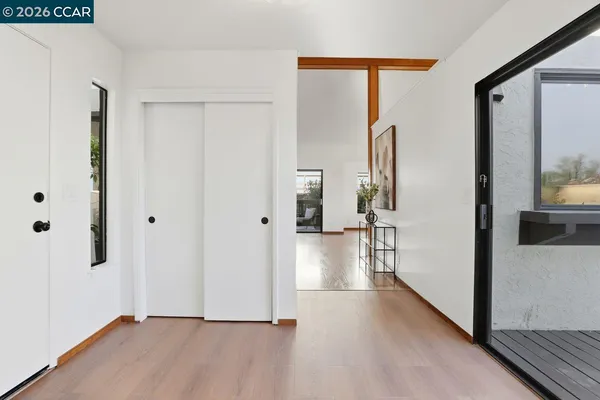 a view of hallway with wooden floor and window