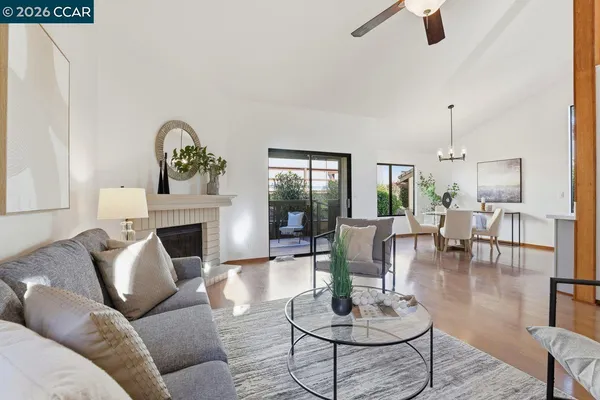 a living room with furniture a fireplace and a table