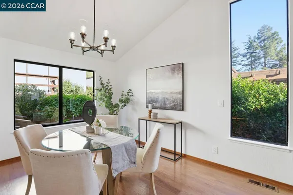 a view of a dining room with furniture window and wooden floor