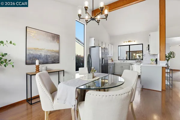 a view of a dining room with furniture wooden floor and a chandelier