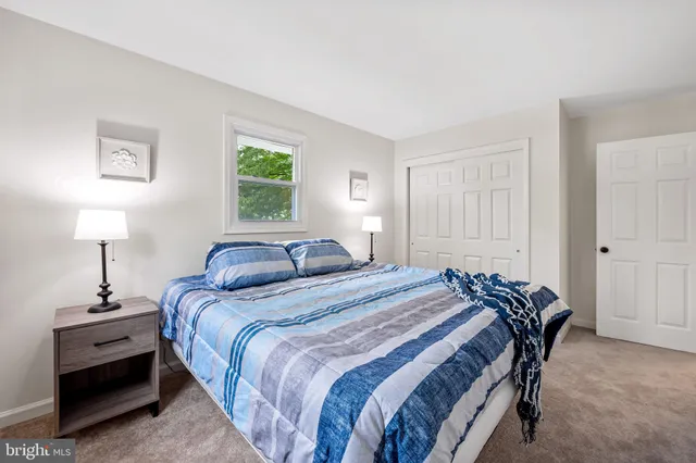 a bedroom with a bed and a lamp