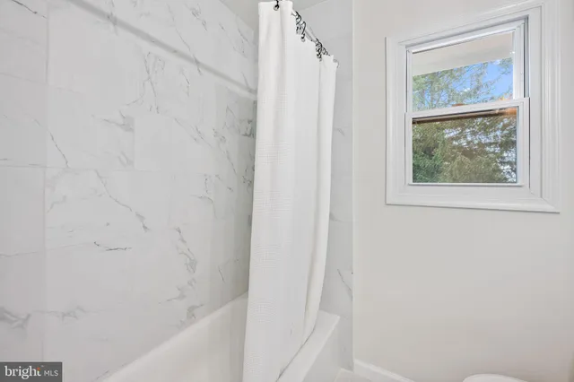a bathroom with a shower curtain