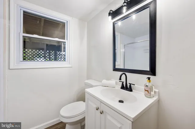 a bathroom with a toilet sink and mirror