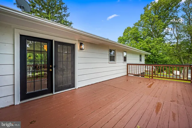 a view of a house with a wooden deck