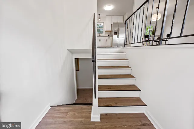 a view of entryway and hall with wooden floor