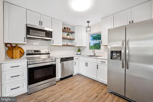 a kitchen with a refrigerator stove and microwave