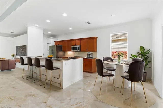 a living room with furniture and kitchen view