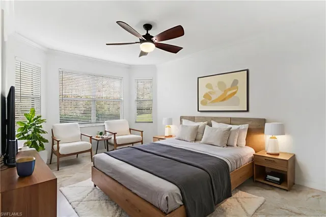 a bedroom with a large bed and a potted plant