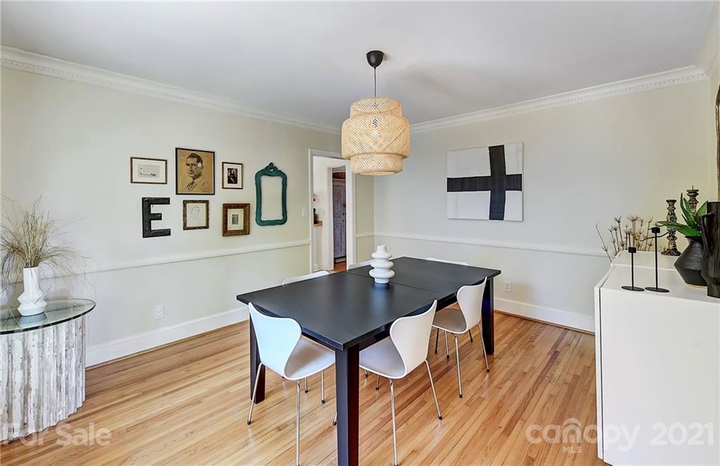 6119 Glenridge Road Charlotte, NC 28211 - Photo 11 of 41 a view of a dining room with furniture and wooden floor