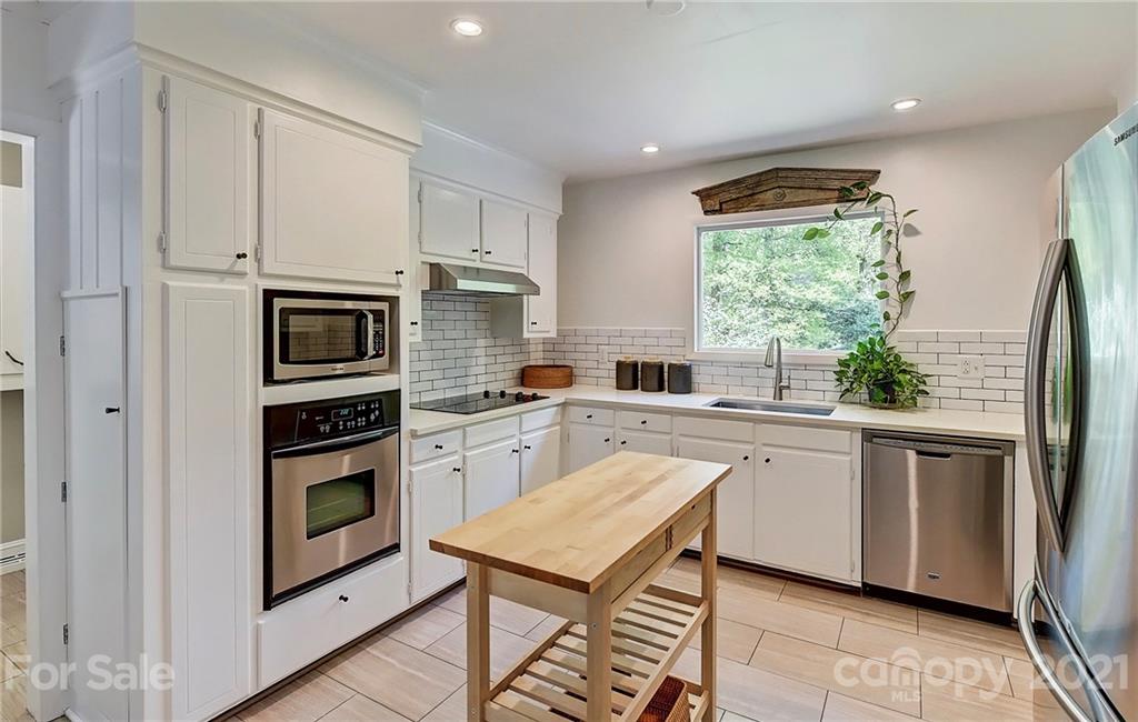 6119 Glenridge Road Charlotte, NC 28211 - Photo 13 of 41 a kitchen with stainless steel appliances granite countertop a refrigerator sink and stove