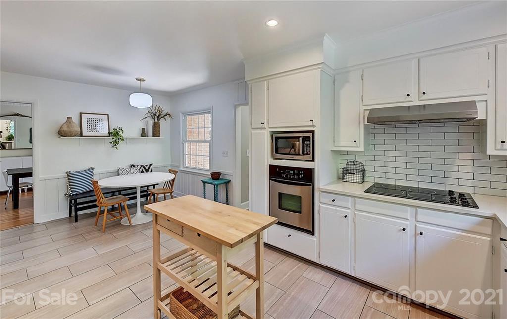 6119 Glenridge Road Charlotte, NC 28211 - Photo 15 of 41 a living room with furniture a dining table and kitchen view