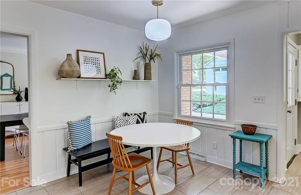 6119 Glenridge Road Charlotte, NC 28211 - Photo 16 of 41 a view of a dining room with furniture and a window