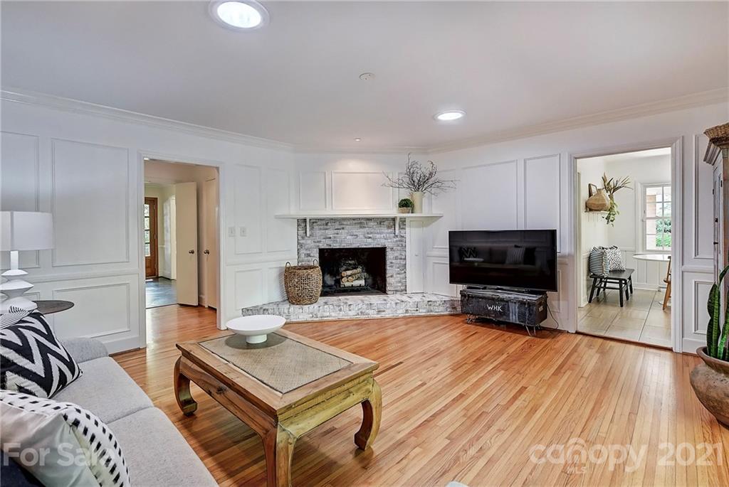 6119 Glenridge Road Charlotte, NC 28211 - Photo 18 of 41 a living room with furniture a flat screen tv and a fireplace