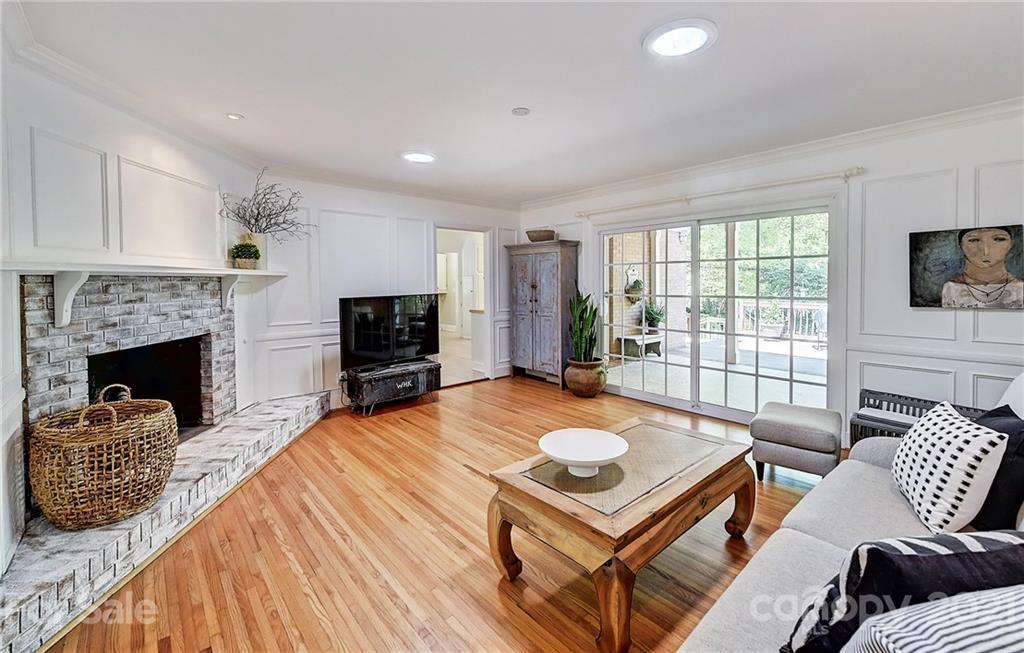 6119 Glenridge Road Charlotte, NC 28211 - Photo 20 of 41 a living room with furniture a flat screen tv and a fireplace