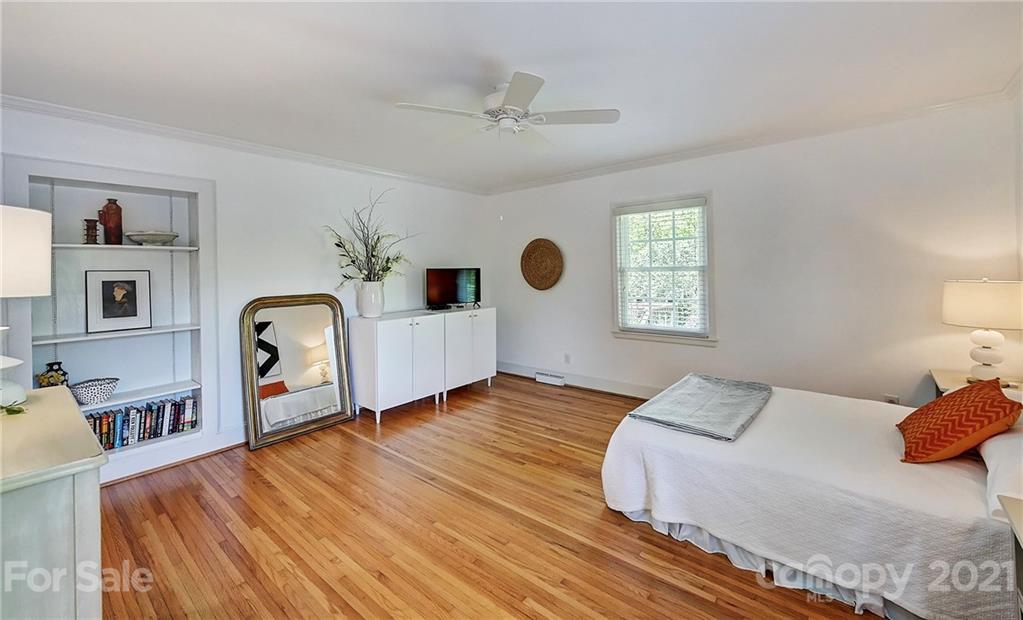 6119 Glenridge Road Charlotte, NC 28211 - Photo 22 of 41 a spacious bedroom with a bed dresser and a window