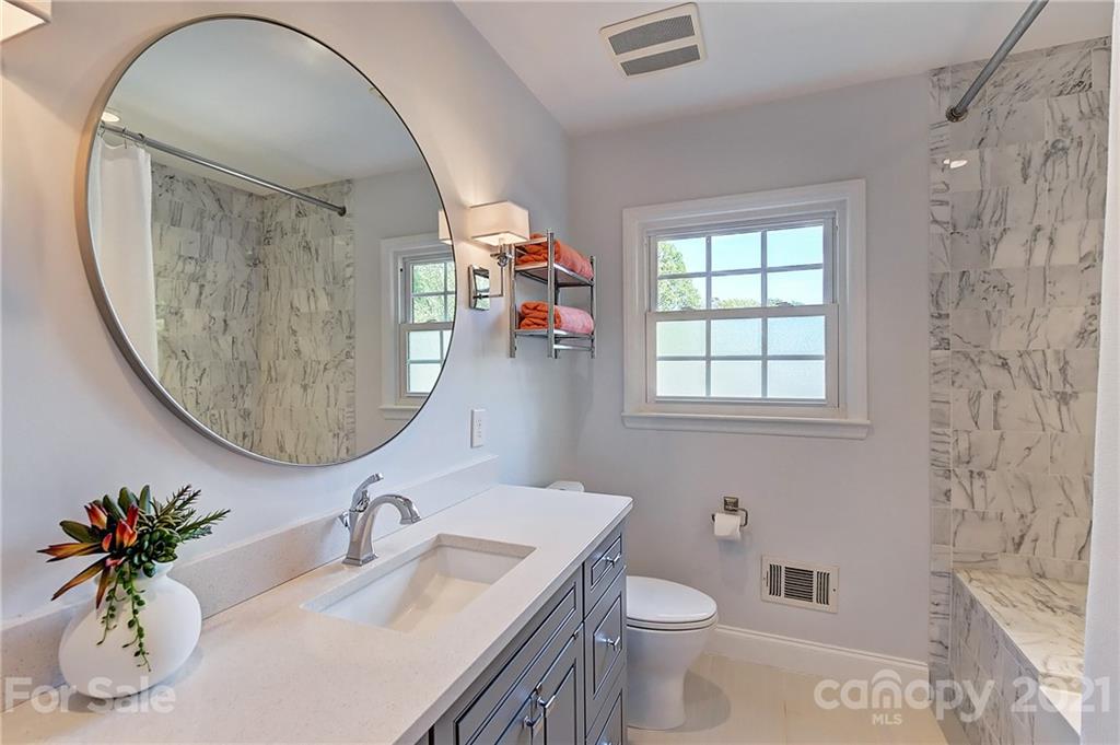 6119 Glenridge Road Charlotte, NC 28211 - Photo 26 of 41 a bathroom with a toilet sink and mirror