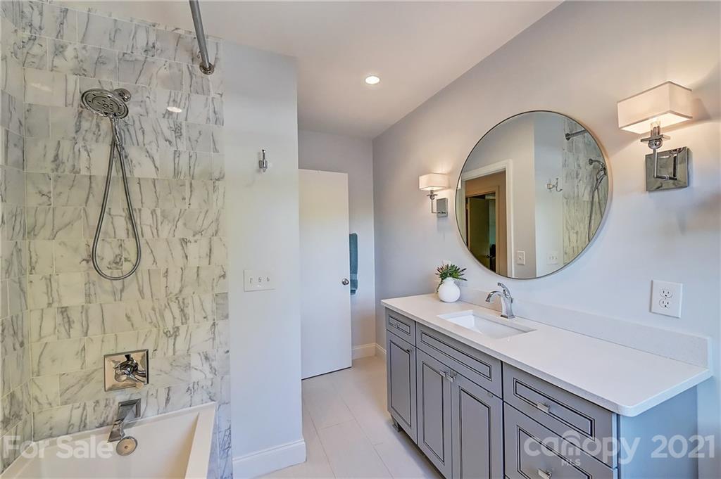6119 Glenridge Road Charlotte, NC 28211 - Photo 27 of 41 a bathroom with a double vanity sink mirror and shower