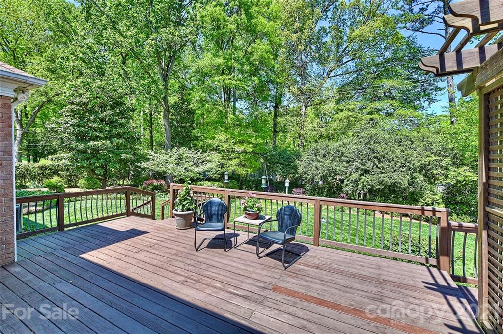6119 Glenridge Road Charlotte, NC 28211 - Photo 31 of 41 a view of house with deck outdoor seating and trees