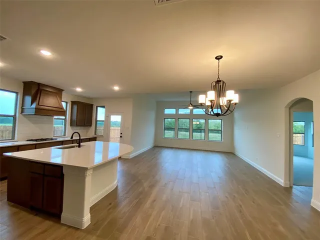 a view of a kitchen counter top space and wooden floor