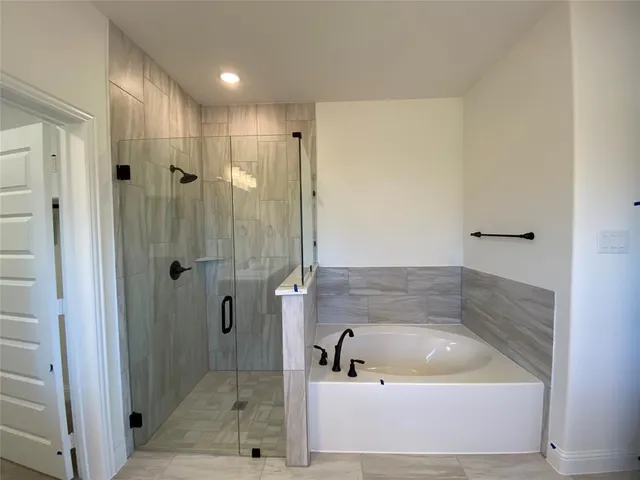 a bathroom with a bathtub and a shower