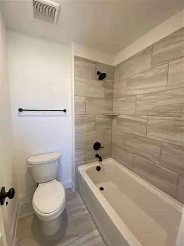 a bathroom with a toilet and a bathtub