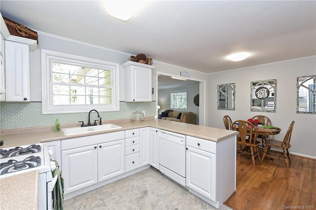 725 Lochridge Road Charlotte, NC 28209 - Photo 11 of 25 a kitchen with a sink stove and cabinets