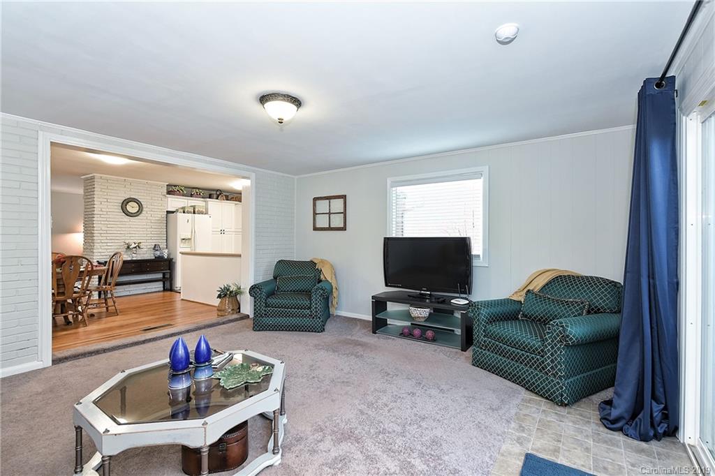 725 Lochridge Road Charlotte, NC 28209 - Photo 13 of 25 a living room with furniture and a flat screen tv