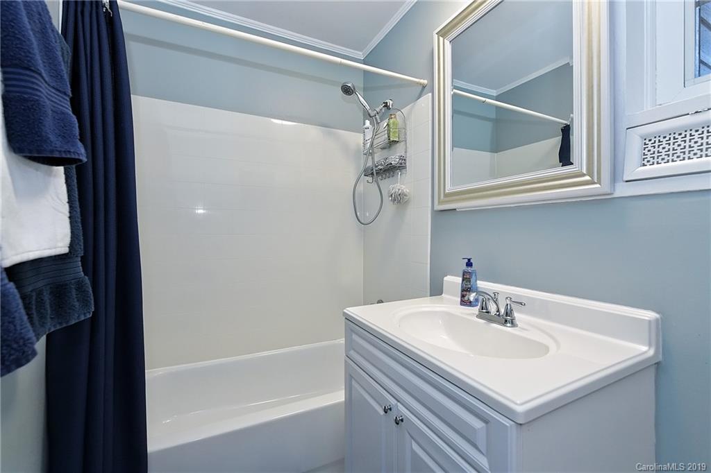 725 Lochridge Road Charlotte, NC 28209 - Photo 17 of 25 a bathroom with a sink and a mirror