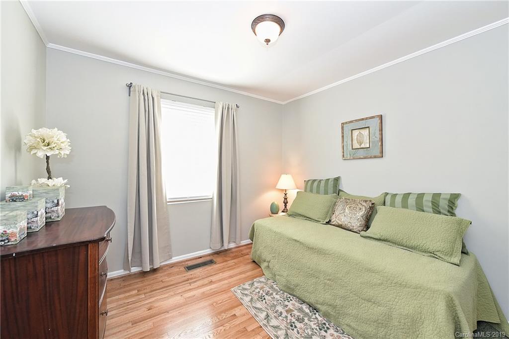 725 Lochridge Road Charlotte, NC 28209 - Photo 19 of 25 a bed room with a bed mirror and a night stand