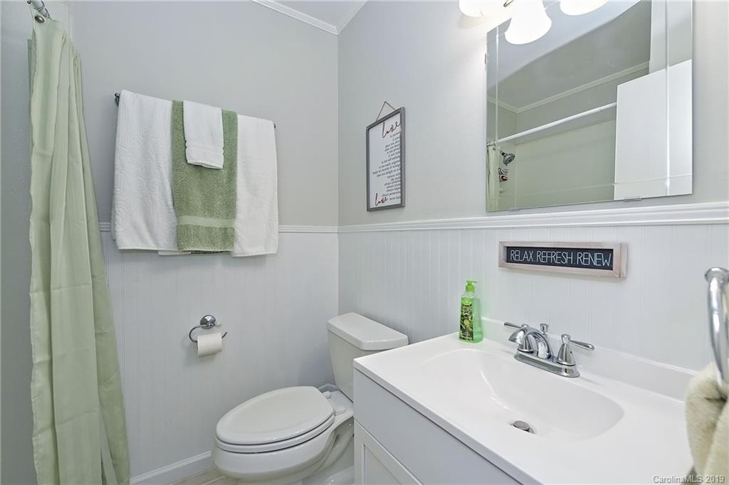 725 Lochridge Road Charlotte, NC 28209 - Photo 21 of 25 a bathroom with a sink a toilet and mirror