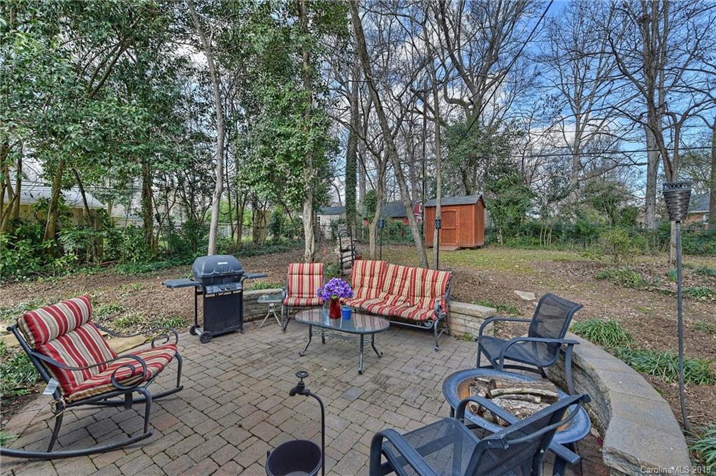 725 Lochridge Road Charlotte, NC 28209 - Photo 22 of 25 a backyard of a house with table and chairs