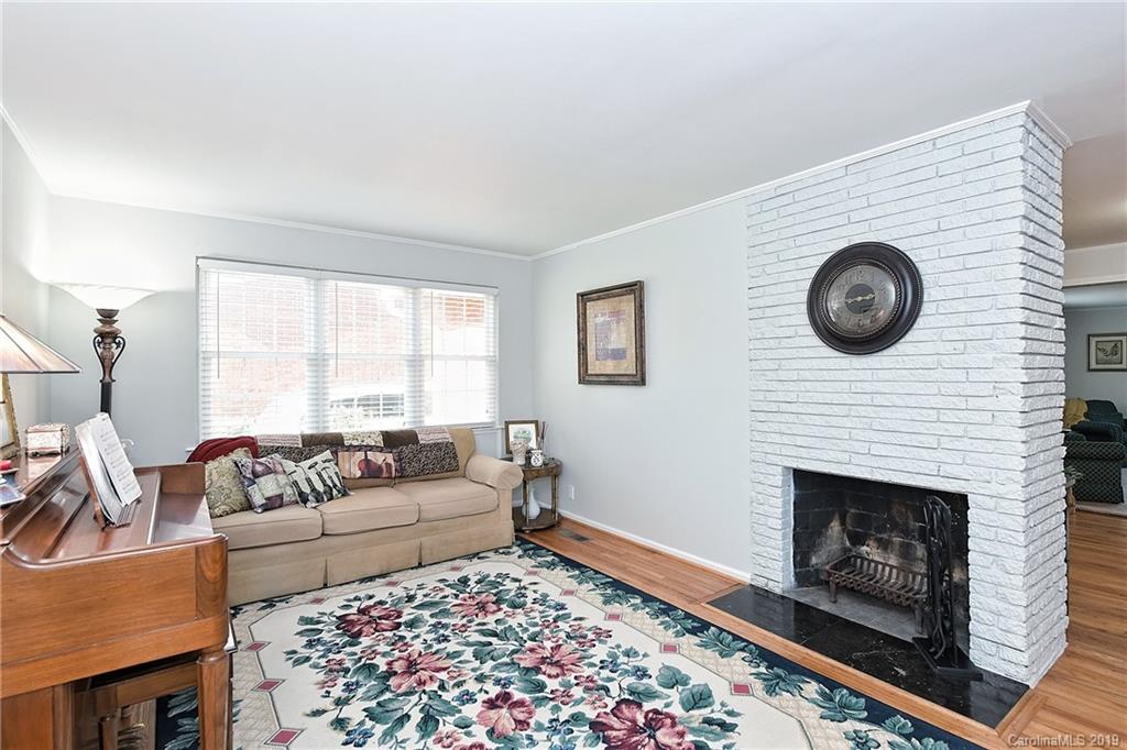 725 Lochridge Road Charlotte, NC 28209 - Photo 4 of 25 a living room with furniture and a fireplace