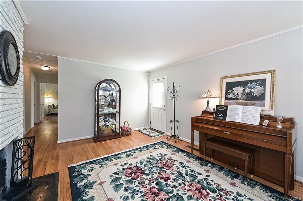 725 Lochridge Road Charlotte, NC 28209 - Photo 5 of 25 a living room with furniture and a piano