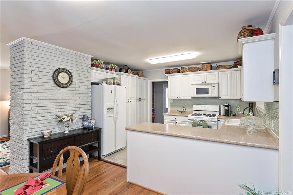 725 Lochridge Road Charlotte, NC 28209 - Photo 9 of 25 a kitchen with stainless steel appliances granite countertop a refrigerator and a stove top oven