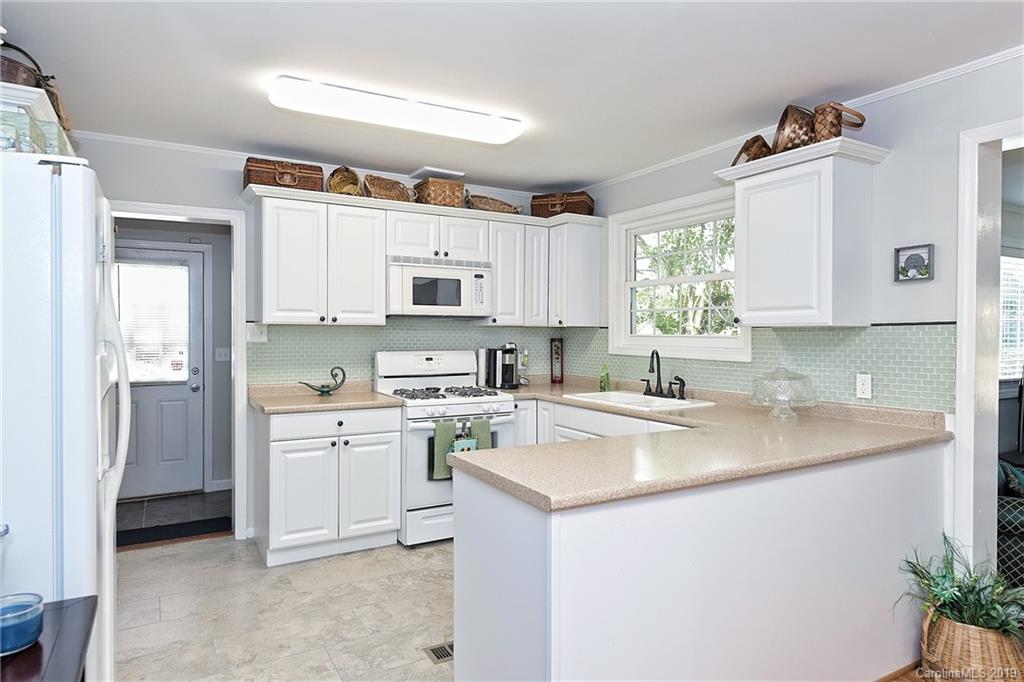725 Lochridge Road Charlotte, NC 28209 - Photo 10 of 25 a kitchen with cabinets appliances a sink and a window