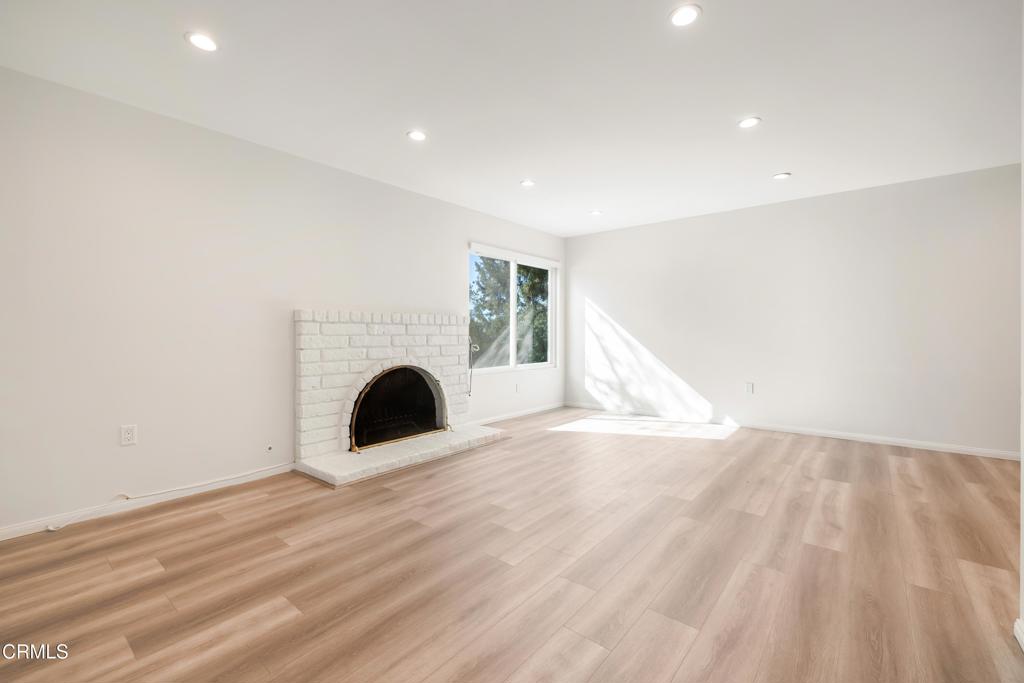 2915 Hopeton Road La Crescenta, CA 91214 - Photo 24 of 41 a view of an empty room with wooden floor fireplace and a window