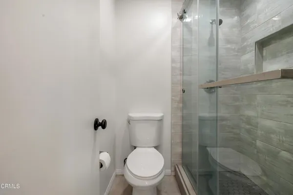 a bathroom with a toilet and a shower