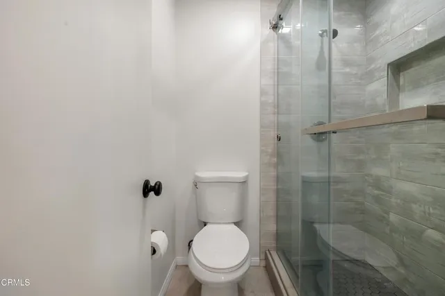 a bathroom with a toilet and a shower