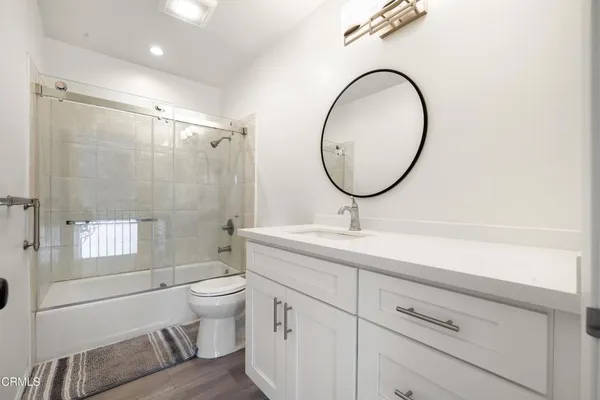 a bathroom with a toilet a sink and a mirror