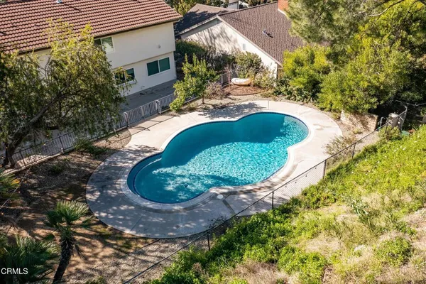 a view of a swimming pool with a yard