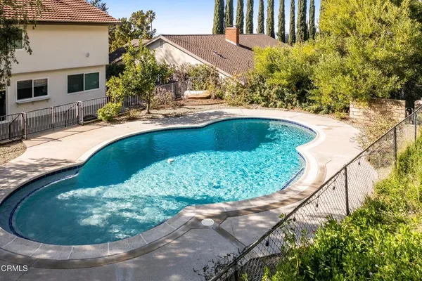 a view of a swimming pool with a yard
