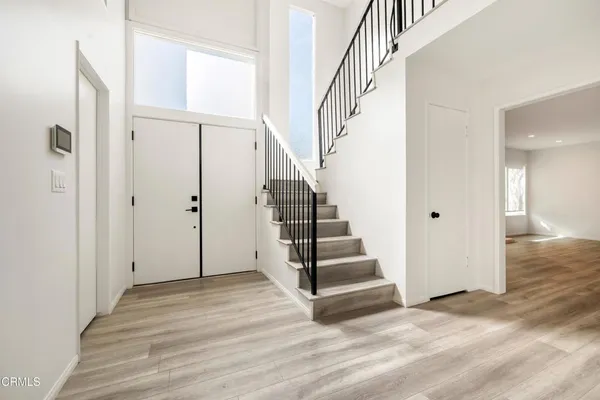 a view of entryway with wooden floor and staircase